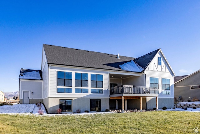 back of house featuring a yard and a deck