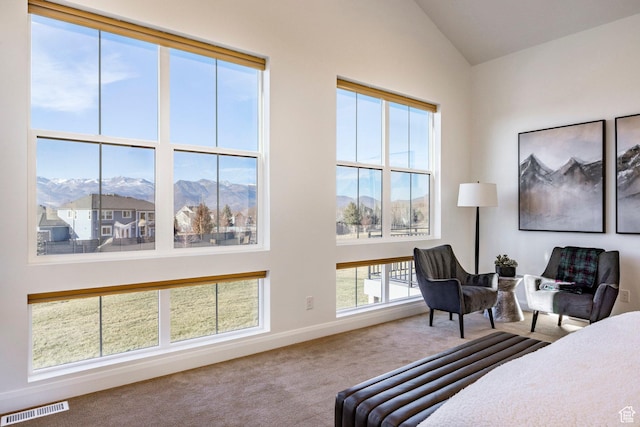 carpeted bedroom with a mountain view and lofted ceiling