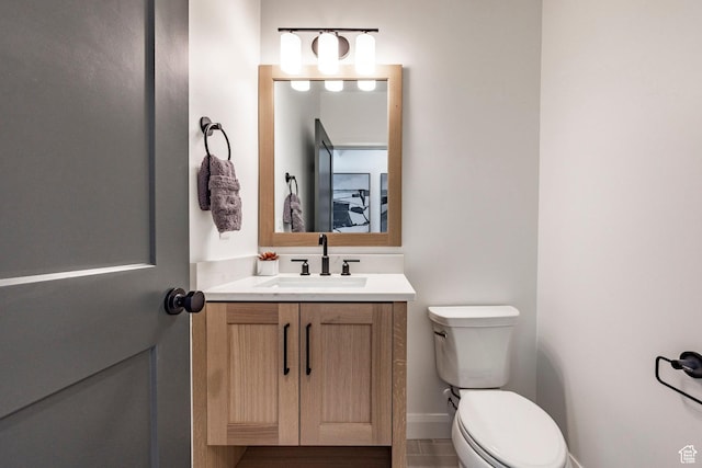 bathroom featuring tile patterned floors, vanity, and toilet