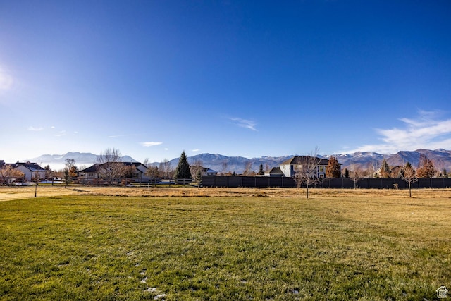view of yard with a mountain view and a rural view