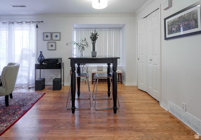 875 E Arrowhead Ln S Unit 42, Murray, UT 84107 - dining space with ornamental molding and hardwood / wood-style flooring