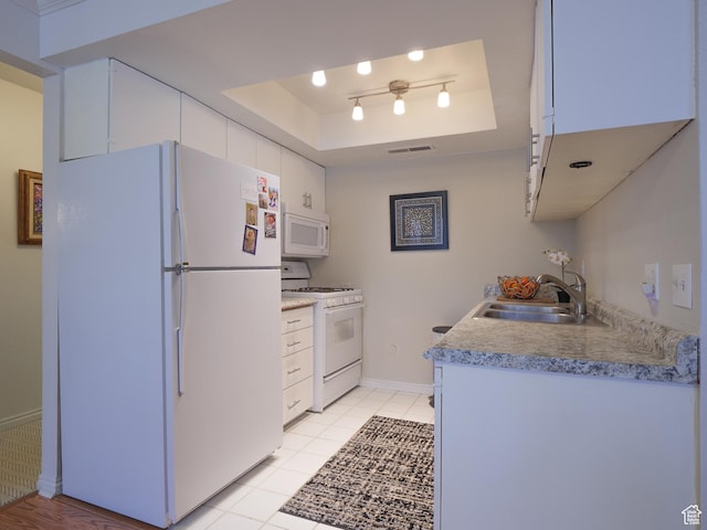 875 E Arrowhead Ln S Unit 42, Murray, UT 84107 - kitchen featuring a raised ceiling, white cabinetry, sink, and white appliances