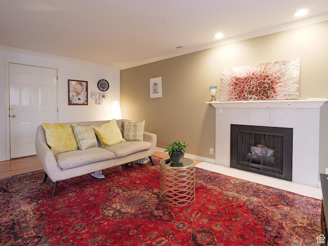875 E Arrowhead Ln S Unit 42, Murray, UT 84107 - living room featuring ornamental molding, a tiled fireplace, wood finished floors, and recessed lighting