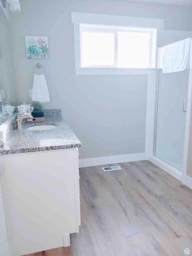 276 W Seasons Ln, Garden City, UT 84028 - full bath with wood finished floors, vanity, and a shower stall