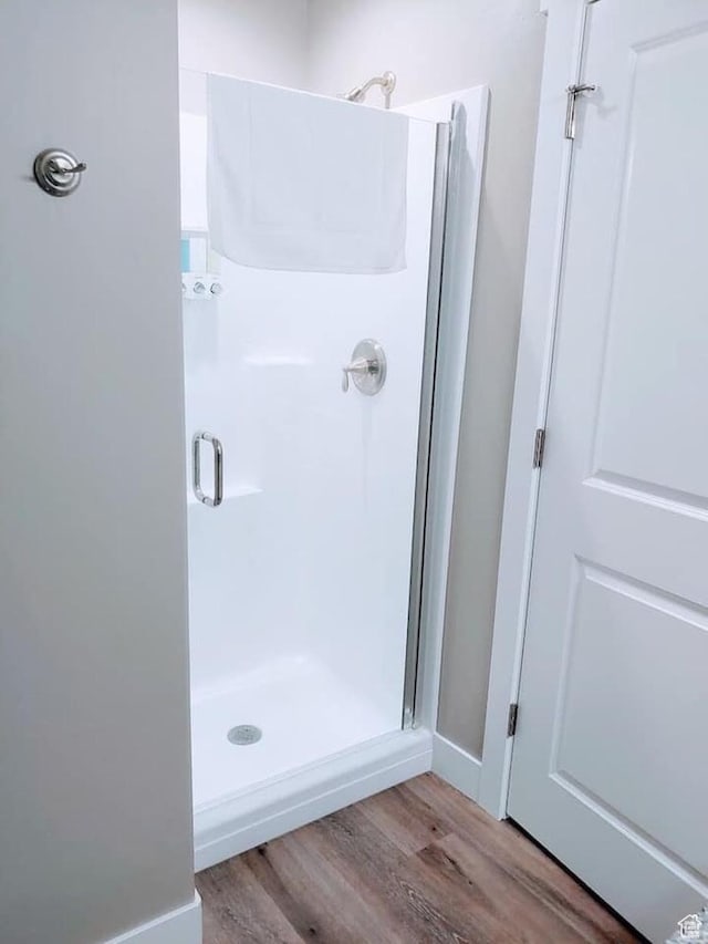 276 W Seasons Ln, Garden City, UT 84028 - bathroom featuring a shower stall and wood finished floors