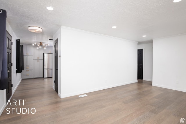 4748 S 700 E Unit 97, Murray, UT 84107 - empty room featuring a textured ceiling, wood finished floors, a chandelier, recessed lighting, and baseboards