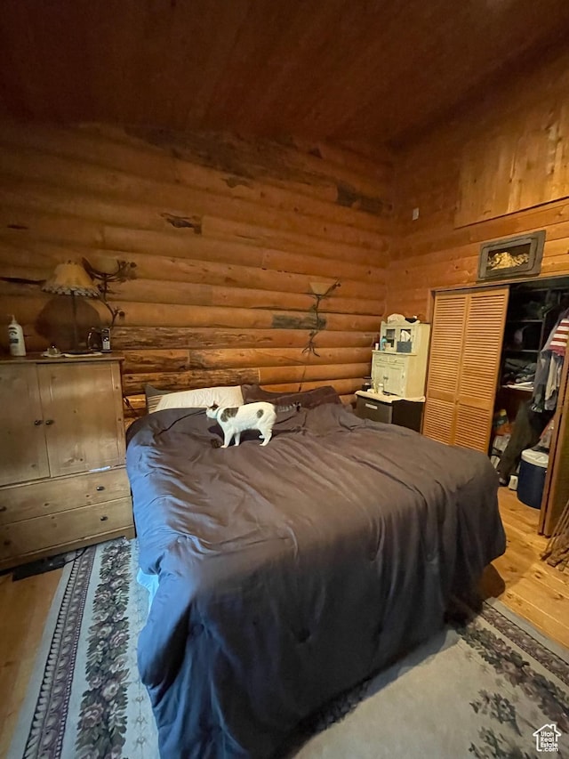 2637 N Water Canyon Ave, Huntsville, UT 84317 - bedroom featuring rustic walls, a closet, and hardwood / wood-style floors