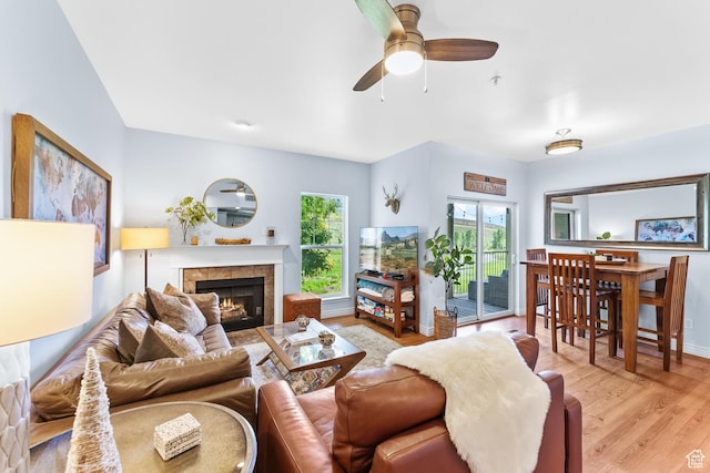 900 Bitner Rd Unit K25, Park City, UT 84098 - living room with ceiling fan, a tiled fireplace, and light hardwood / wood-style flooring