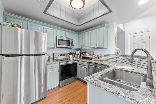 900 Bitner Rd Unit K25, Park City, UT 84098 - kitchen featuring sink, light wood-type flooring, tasteful backsplash, light stone counters, and stainless steel appliances