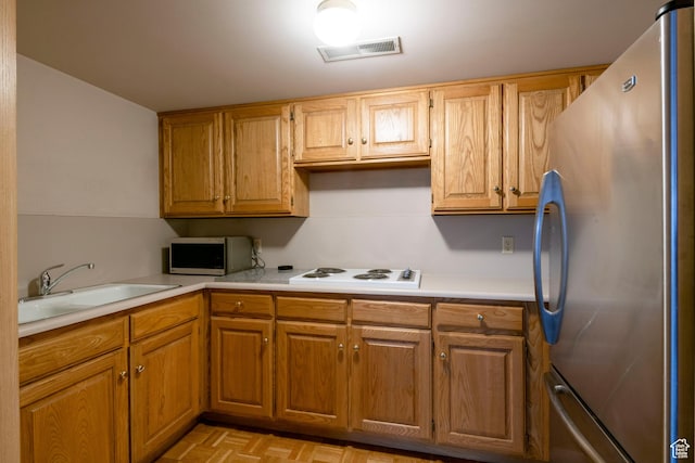 426 S 1000 E Unit 600, Salt Lake City, UT 84102 - kitchen featuring appliances with stainless steel finishes, light countertops, and brown cabinetry