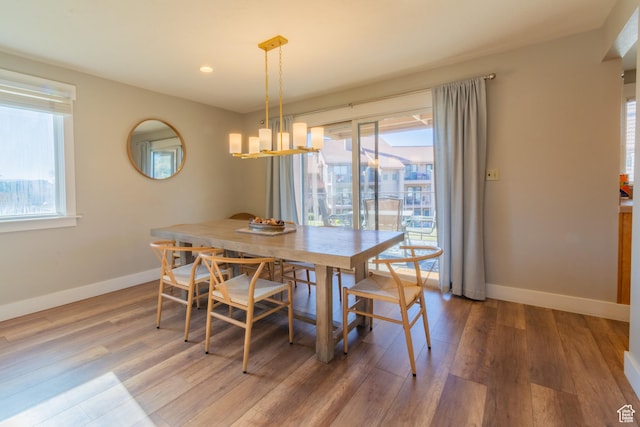 860 S Village Rd Unit Y8, St George, UT 84770 - dining area featuring a chandelier, plenty of natural light, and hardwood / wood-style floors
