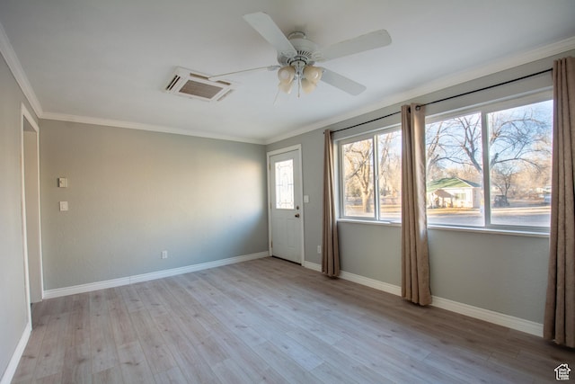 empty room featuring ceiling fan, crown molding, and light hardwood / wood-style flooring