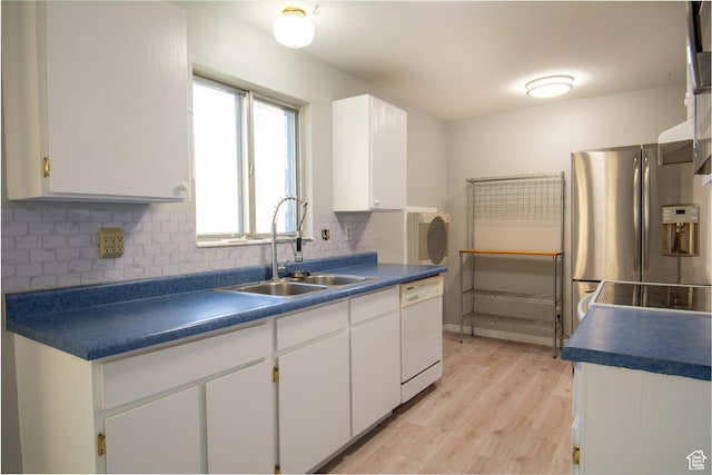 kitchen featuring white cabinets, light wood-type flooring, white dishwasher, and sink