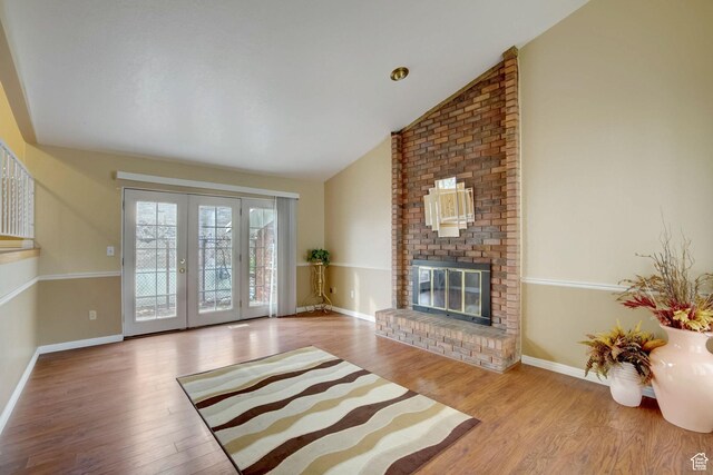 5238 S 2100 W, Roy, UT 84067 - living room with light hardwood / wood-style flooring, lofted ceiling, and a brick fireplace