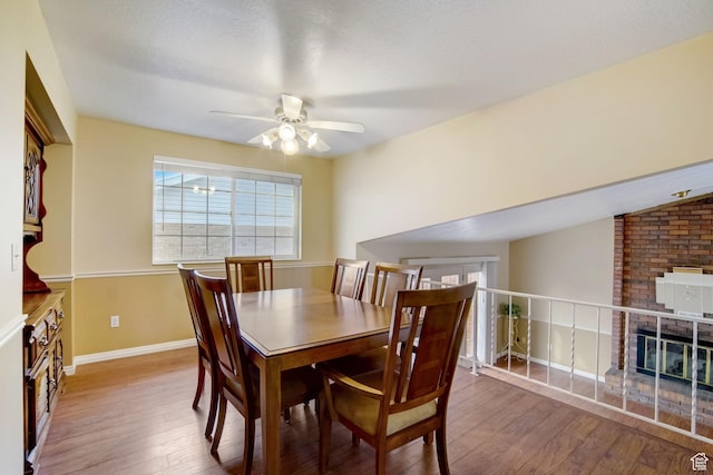 5238 S 2100 W, Roy, UT 84067 - dining space featuring hardwood / wood-style floors, vaulted ceiling, a brick fireplace, and ceiling fan