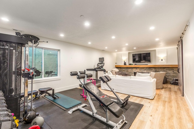 exercise area featuring light hardwood / wood-style floors