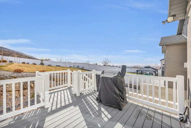 wooden terrace featuring a grill