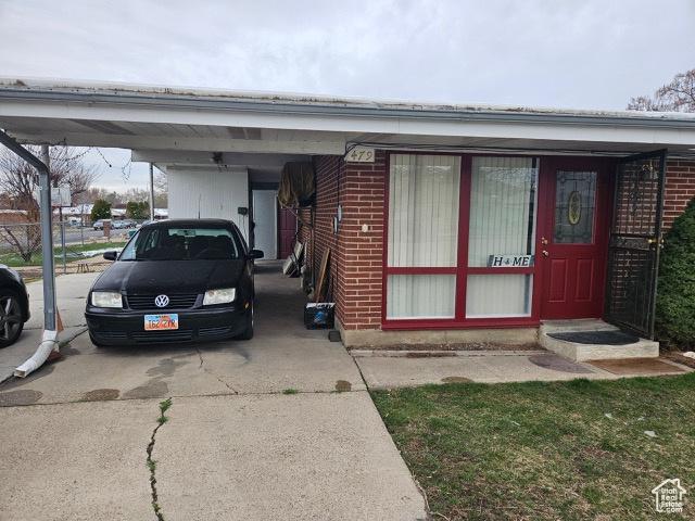 479 N Valeria Dr E, Layton, UT 84041 - exterior space with a carport, concrete driveway, and brick siding