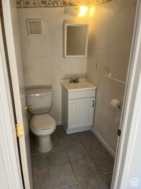 479 N Valeria Dr E, Layton, UT 84041 - half bath featuring tile patterned floors, visible vents, toilet, baseboards, and vanity