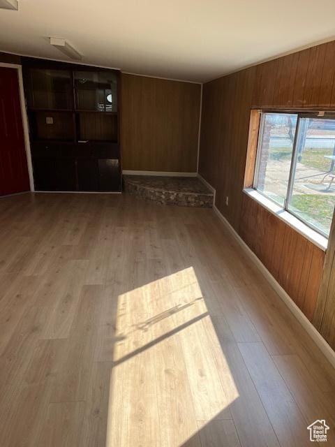 479 N Valeria Dr E, Layton, UT 84041 - unfurnished living room with wood walls, baseboards, and wood finished floors