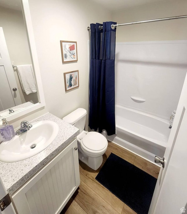 573 S Aspen Dr, Garden City, UT 84028 - full bathroom featuring hardwood / wood-style floors, vanity, shower / tub combo, and toilet