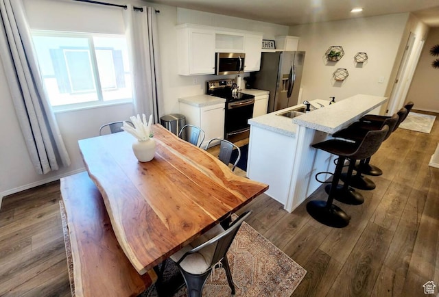 573 S Aspen Dr, Garden City, UT 84028 - dining area featuring sink and dark wood-type flooring