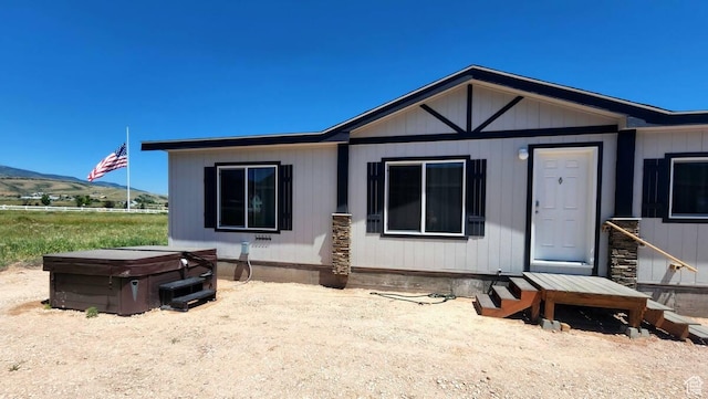 573 S Aspen Dr, Garden City, UT 84028 - rear view of house with a mountain view and a hot tub