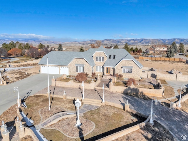 1402 Shepherd Dr, Wellington, UT 84542 - view of front of house featuring a mountain view and a garage