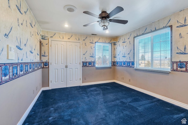 1402 Shepherd Dr, Wellington, UT 84542 - unfurnished bedroom with ceiling fan, a closet, and dark colored carpet