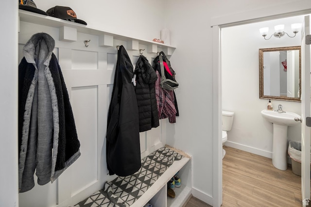 mudroom with light hardwood / wood-style flooring and sink