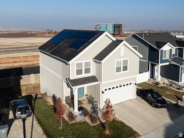 view of front of house featuring solar panels and a garage