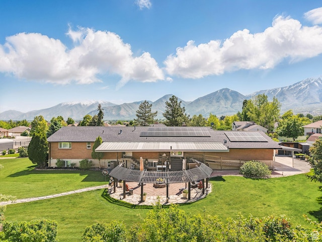 208 S 1100 E, Payson, UT 84651 - back of house featuring a patio, roof mounted solar panels, a deck with mountain view, a lawn, and stucco siding