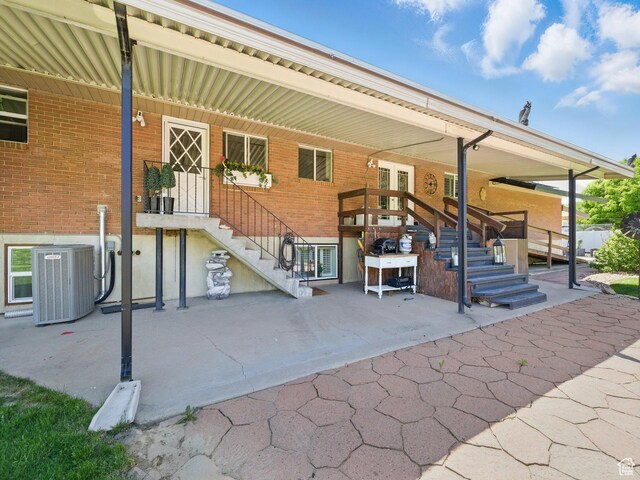 208 S 1100 E, Payson, UT 84651 - rear view of property featuring cooling unit, stairway, brick siding, and a patio
