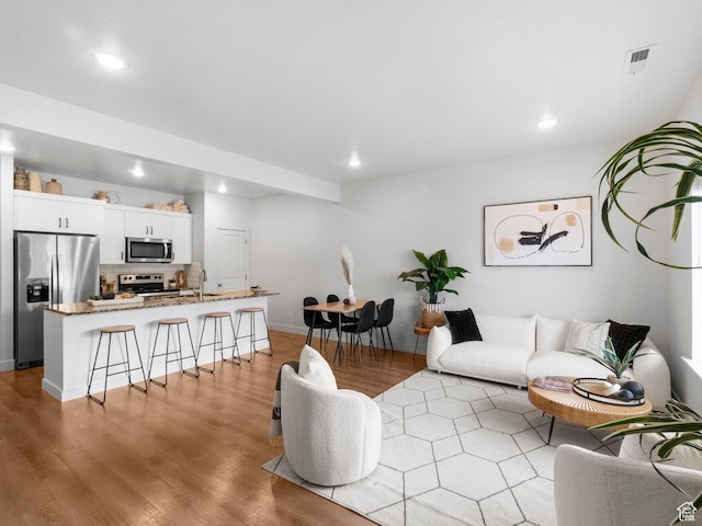 364 S 1580 E, Hyrum, UT 84319 - living room featuring light hardwood / wood-style floors and sink