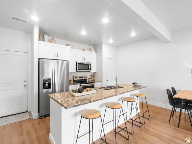 364 S 1580 E, Hyrum, UT 84319 - kitchen featuring a kitchen island with sink, sink, appliances with stainless steel finishes, light hardwood / wood-style floors, and white cabinetry