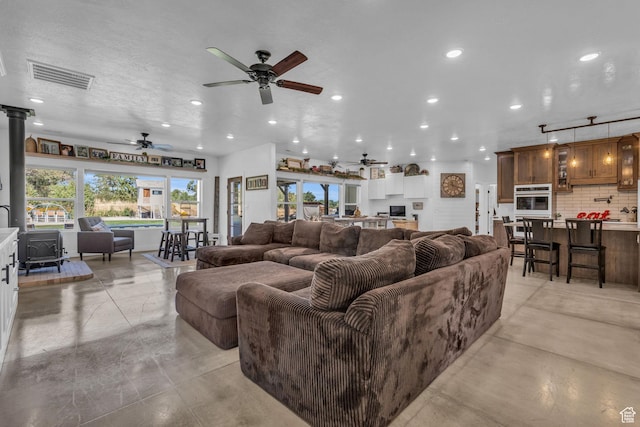30 W 400 N, Fillmore, UT 84631 - living room featuring a textured ceiling, a wood stove, and ceiling fan