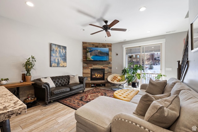 13579 N Hillclimb Ln, Kamas, UT 84036 - living room with ceiling fan, a fireplace, and light hardwood / wood-style flooring