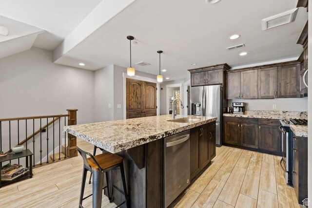 13579 N Hillclimb Ln, Kamas, UT 84036 - kitchen with sink, a center island with sink, light hardwood / wood-style floors, and appliances with stainless steel finishes