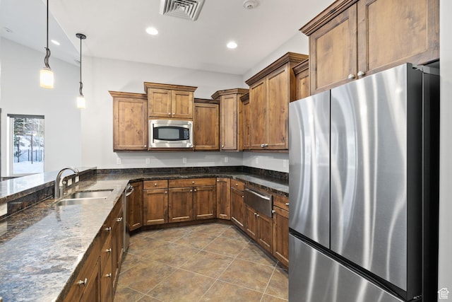 13579 N Hillclimb Ln, Kamas, UT 84036 - kitchen with sink, stainless steel appliances, dark stone counters, decorative light fixtures, and dark tile patterned flooring