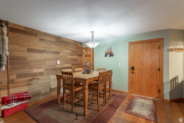 407 S Vasels Rd Unit 65, Brian Head, UT 84719 - dining space with wood walls and dark hardwood / wood-style flooring