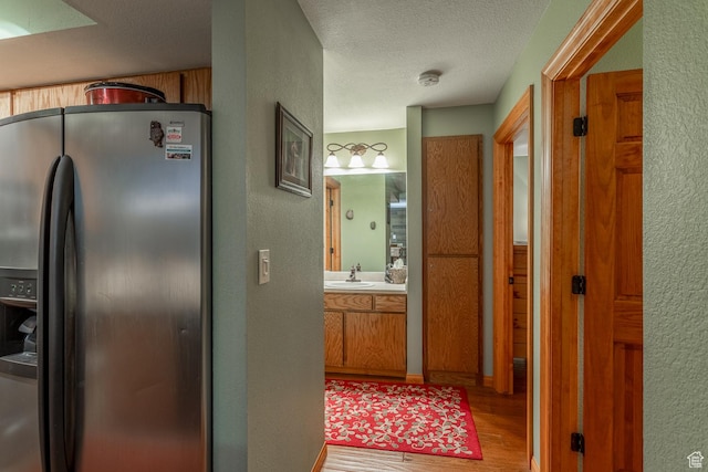 407 S Vasels Rd Unit 65, Brian Head, UT 84719 - corridor featuring wood-type flooring, a textured ceiling, and sink