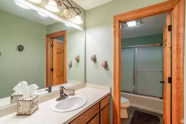 407 S Vasels Rd Unit 65, Brian Head, UT 84719 - full bathroom featuring tile patterned flooring, vanity, enclosed tub / shower combo, and toilet
