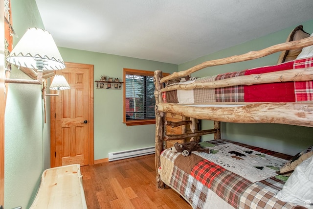 407 S Vasels Rd Unit 65, Brian Head, UT 84719 - bedroom featuring wood-type flooring and a baseboard heating unit