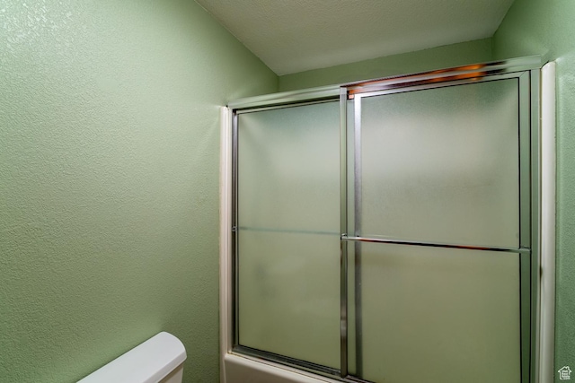 407 S Vasels Rd Unit 65, Brian Head, UT 84719 - bathroom with combined bath / shower with glass door, toilet, and a textured ceiling