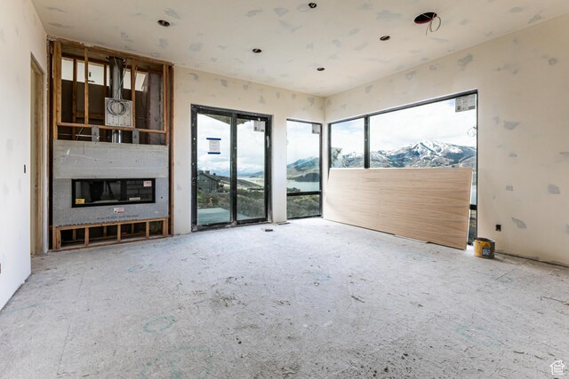 688 E Longview Dr, Hideout, UT 84036 - unfurnished living room with a glass covered fireplace and a mountain view