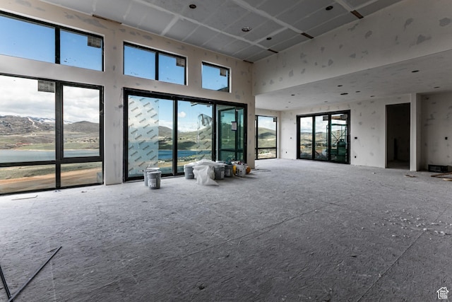 688 E Longview Dr, Hideout, UT 84036 - unfurnished living room with a healthy amount of sunlight and a towering ceiling