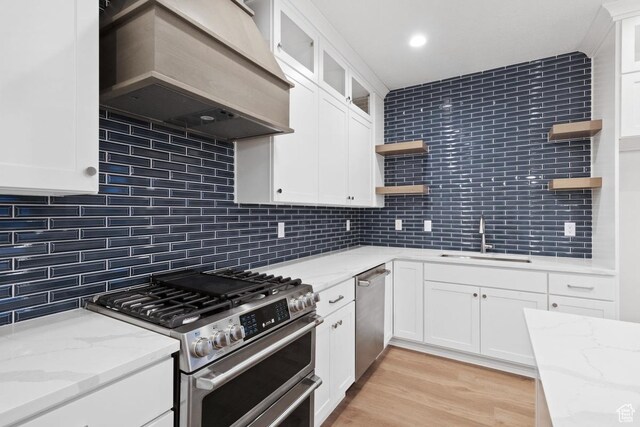 11423 S Watercourse Rd, South Jordan, UT 84009 - kitchen with open shelves, stainless steel appliances, a sink, custom range hood, and decorative backsplash