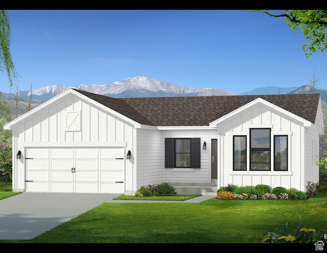 modern farmhouse style home with board and batten siding, a mountain view, a shingled roof, and a garage