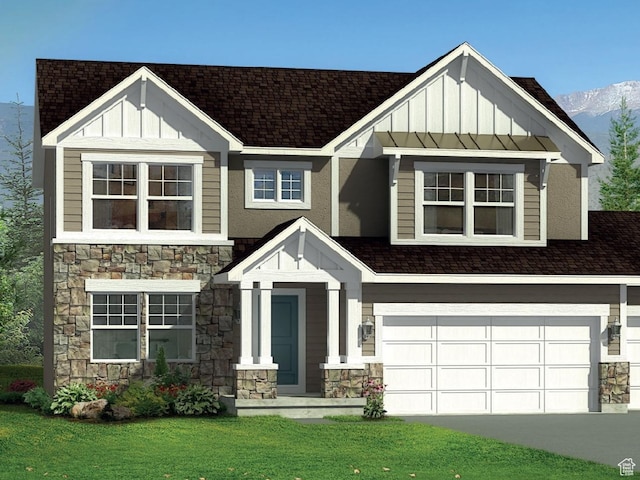 view of front facade featuring a mountain view, a front yard, and a garage