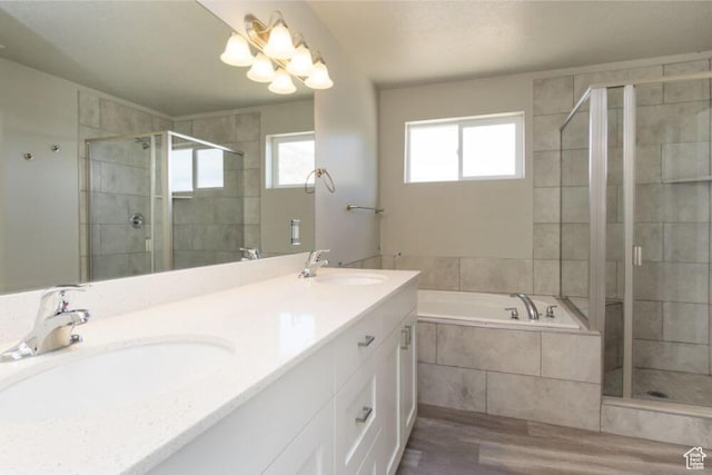 bathroom with hardwood / wood-style floors, vanity, and separate shower and tub